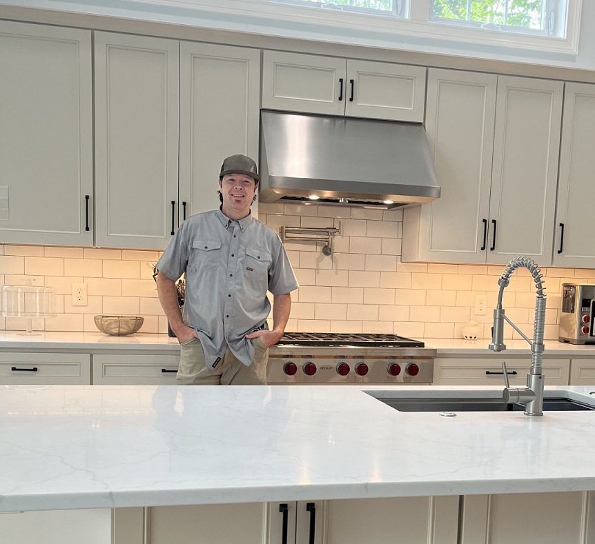 Man in gray shirt in kitchen
