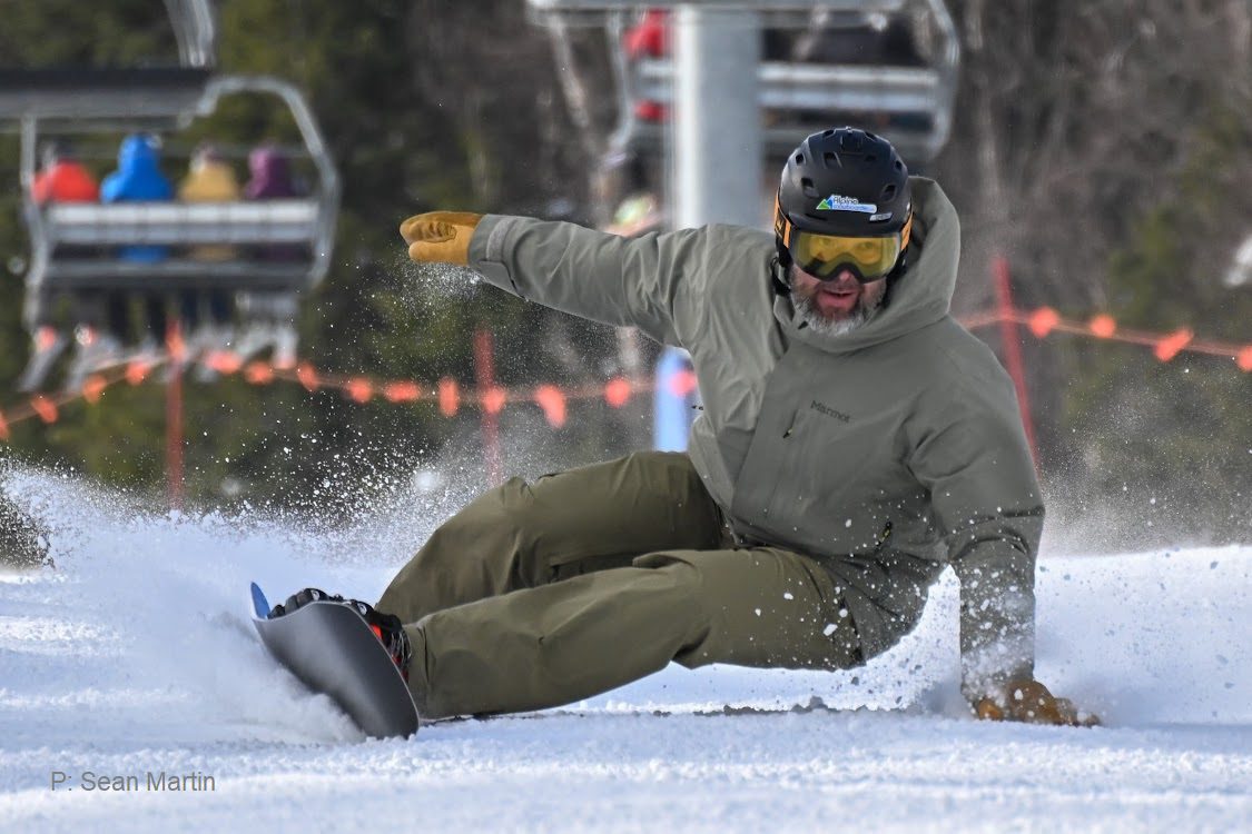Enthusiastic snowboarder in winter gear