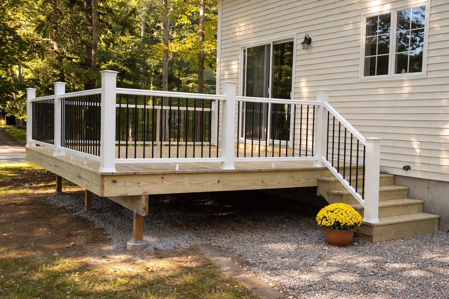 Modern wooden deck with white railing